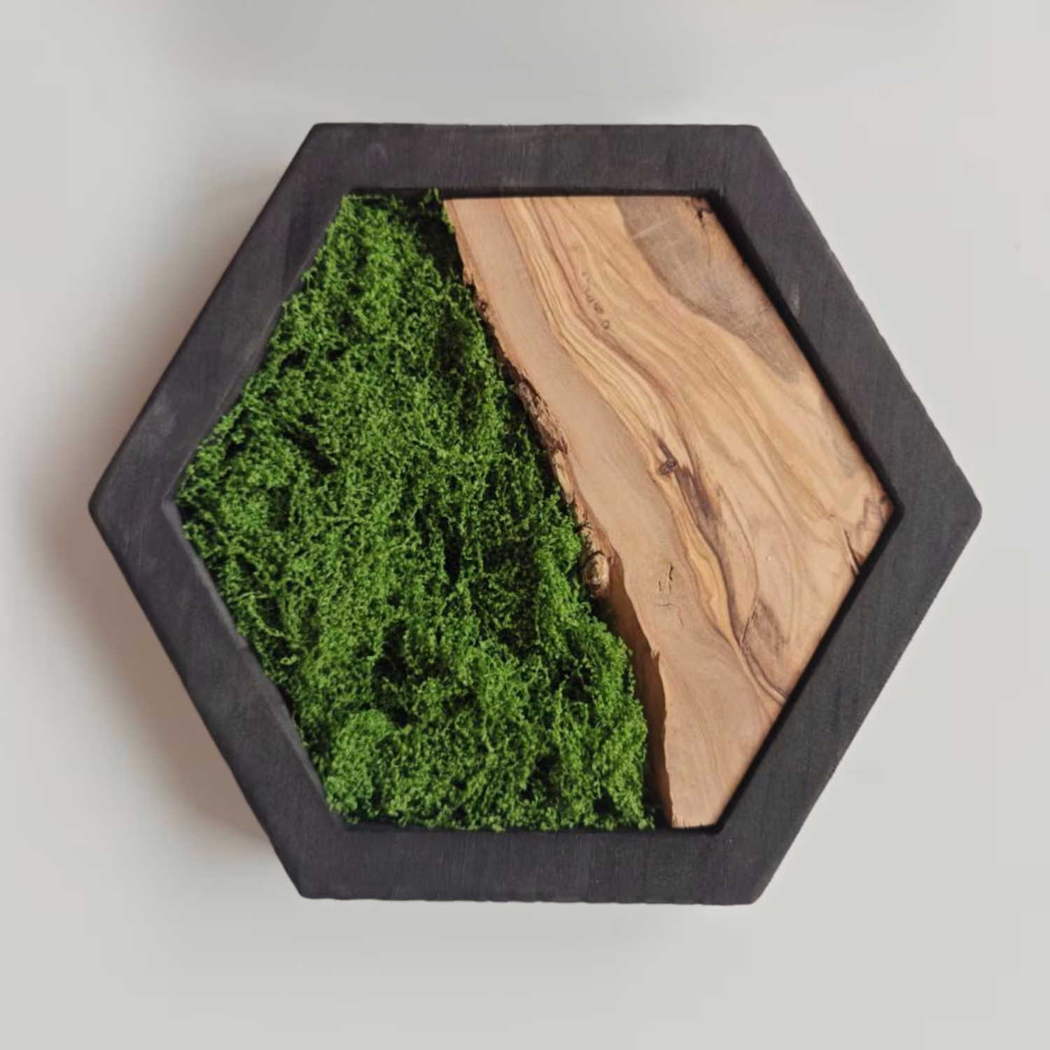 Hexagonal wall art with green moss and olive wood.